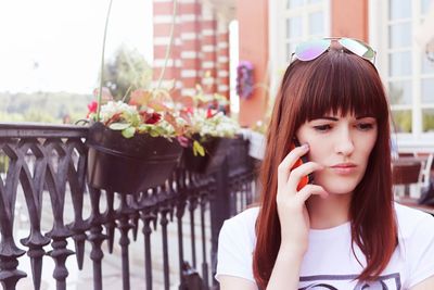 Woman talking on mobile phone in city