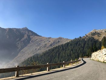 Road by mountain against sky