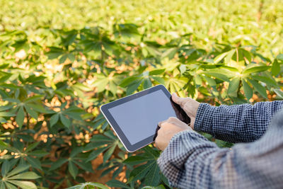 Man holding mobile phone in park