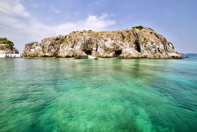 Scenic view of island in sea against sky