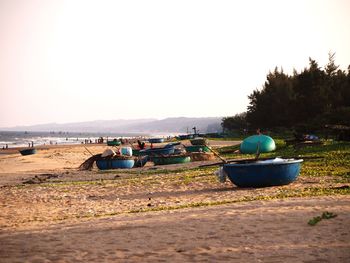 Boat on shore against clear sky