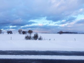 Scenic view of landscape against sky during winter