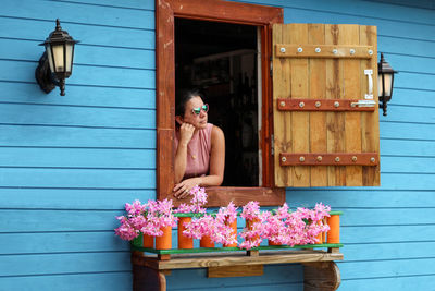 Woman standing by building