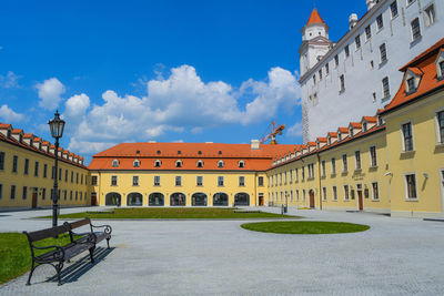 Buildings against cloudy sky