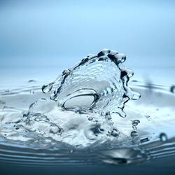 Defokused splash of clear water on a blue background