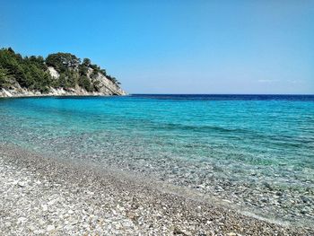 Scenic view of sea against clear blue sky