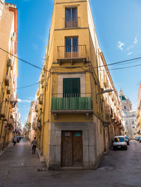 Street amidst buildings against sky in city