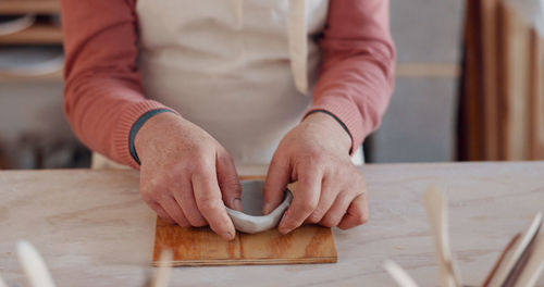 Midsection of man working on table