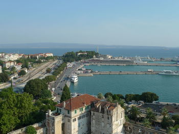 High angle view of city by sea against sky