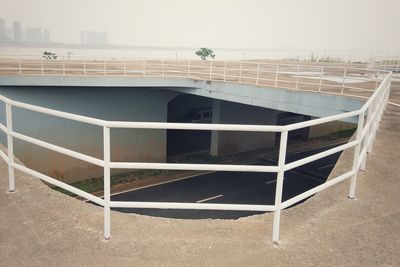 Empty chairs and table against buildings in city
