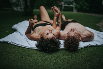 Young woman lying on grass