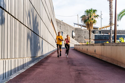 Rear view of woman walking on walkway