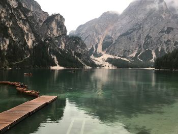 Scenic view of lake by mountains against sky