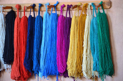 Multi colored clothes hanging on rack in store