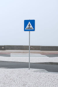 Close-up of road sign against clear sky