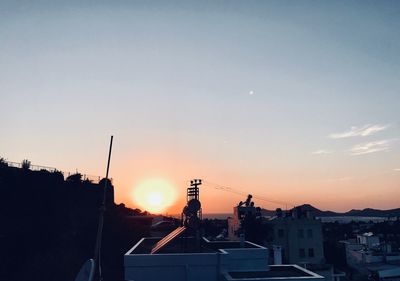 Silhouette buildings against sky during sunset