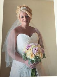 Close-up portrait of happy woman with bouquet