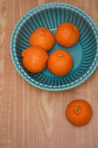High angle view of orange fruits in bowl on table