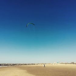 Person paragliding against sky