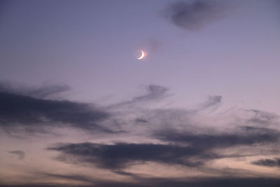 Low angle view of moon against sky at sunset