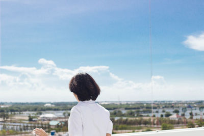 Rear view of woman against sea and sky