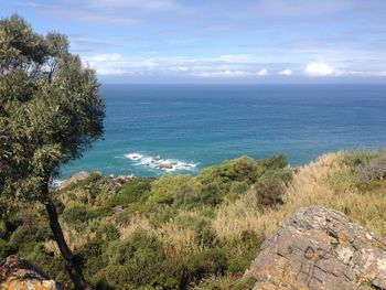 Scenic view of calm sea against cloudy sky