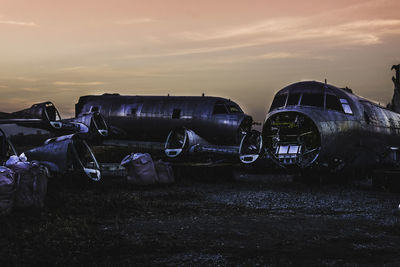 Airplanes against sky at sunset