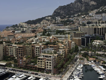 High angle view of buildings by sea against sky