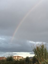 Rainbow over building against sky