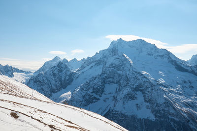 Scenic view of snowcapped mountains against sky