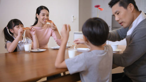 Portrait of a young couple sitting on table