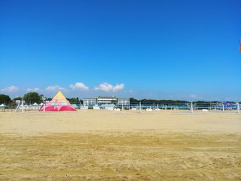 Scenic view of beach against blue sky