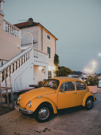 Car on street against buildings in city