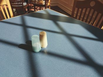 High angle view of salt shakers on table