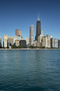 View of buildings in city against blue sky