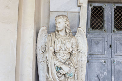 Angel statue by door of church