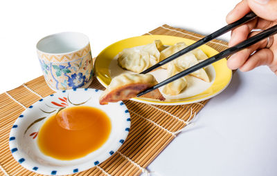 Midsection of man holding tea served on table