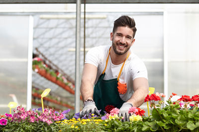Portrait of smiling man working in greenhouse