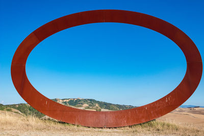 Scenic view of field against clear blue sky