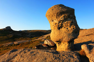 Rock formation against clear blue sky at bucegi natural park