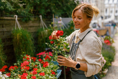 Portrait of young woman holding flowers