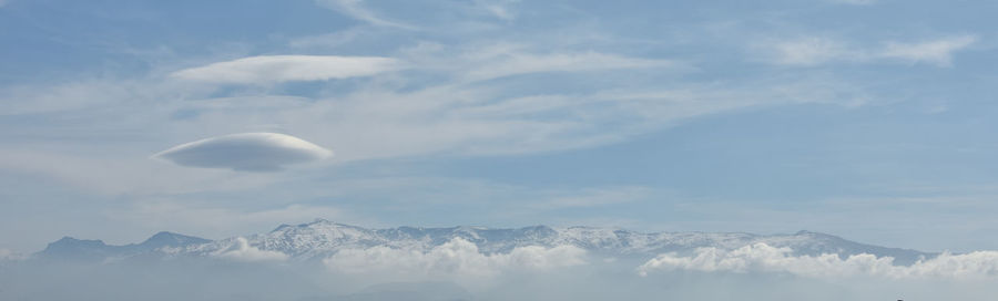 Low angle view of snowcapped mountains against sky