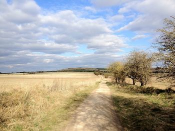 Empty road along countryside landscape