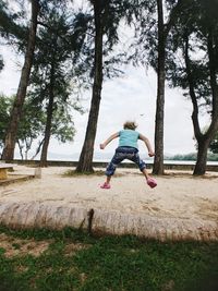 Rear view of girl playing on land