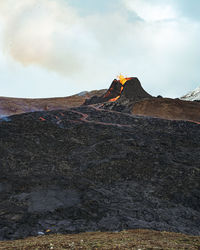 Scenic view of volcanic mountain against sky