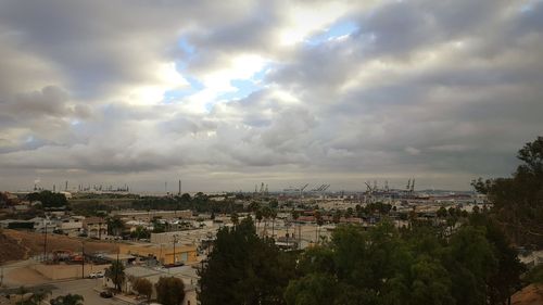 High angle view of cityscape against cloudy sky