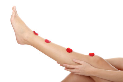Close-up of woman hand against red background