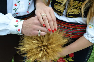 Midsection of woman holding hands