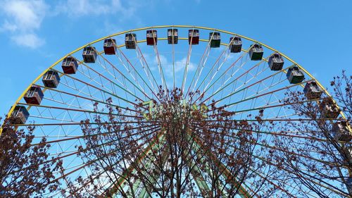 Low angle view of ferris wheel against sky