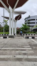 Man riding bicycle on building in city